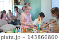 Preteens playing with wooden blocks at educational children's club  143866860