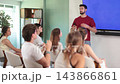 Adult male teacher giving lecture for group in classroom  143866861