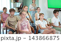 Attentive children and teenagers listening to teacher on chairs inside modern classroom interior  143866875