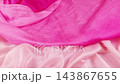 Pink silk fabric falling down on textile background in slow motion. This video is perfect for fashion branding and elegant commercial advertisements.  143867655
