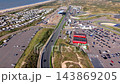 High angle aerial video of full Circuit Zandvoort race track layout start finish straight paddock grandstand holiday park dunes and North Sea coast in North Holland Netherlands stock footage 143869205
