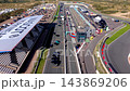 High angle aerial video of start finish straight grid slots Mascot Workwear grandstand pit lane race control tower and paddock at Circuit Zandvoort in North Holland Netherlands stock footage 143869206