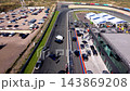 High angle aerial video of pit lane exit pit building Mascot Workwear race track straight sports cars paddock marquees and parking lot at Circuit Zandvoort in North Holland Netherlands footage 143869208