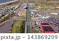 High angle aerial video of start finish straight race track paddock grandstand parking lot campsite dunes and North Sea coast at Circuit Zandvoort in North Holland Netherlands stock footage 143869209