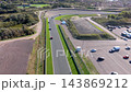 High angle aerial view of race track straight circuit curve sports cars driving asphalt parking lot and coastal sand dunes at Circuit Zandvoort in North Holland Netherlands stock media asset 143869212