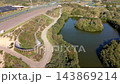 High angle aerial view of race track circuit with natural lake island wooden footbridge path grandstand dunes and asphalt speedway turns at Circuit Zandvoort in North Holland Netherlands 143869214