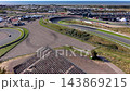 High angle aerial view of race track grandstand banked turn sports cars asphalt course training area paddock and North Sea coastline at Circuit Zandvoort in North Holland Netherlands media asset 143869215