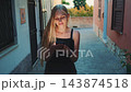 Blonde Woman Using Smartphone in Narrow European Alleyway 143874518