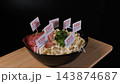 Instant noodles with sausage rotate on a wooden board with E330, E627, E451, E635 and E621 labels in it. Additive risk concept 143874687