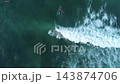 Top down drone view of surfers lineup floating in deep turquoise ocean 143874706