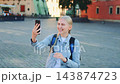 Young blonde woman making smartphone call in European city square 143874723