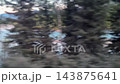 Red boat on river flowing through forested mountain valley, camera panning 143875641