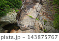 Woman Resting on Rocks at Na Muang Waterfall 2 on Koh Samui 143875767