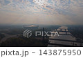 Aerial Drone Footage of Warsaw Cityscape at Sunrise featuring National Stadium, Bridges, and Vistula River 143875950