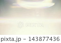 Bright anamorphic lens flare with blue light leaks and bokeh glowing on dark background for cinematic overlay effect 143877436