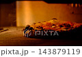Freshly Prepared Pizza Cooking in a Professional Oven. 143879119
