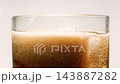 Slow motion closeup cola with ice cubes and bubbles, macro soft drink texture 143887282