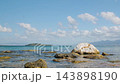 Rocky Shoreline White Boulder Calm Sea Shot In Cinematic K With Gentle Tidal Ripples, Shallow Foreground 143898190