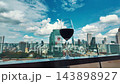 red wine on terrace with Bangkok city skyline at sunset, cocktail on rooftop, vibrant cityscape and luxury panorama view 4k 143898927