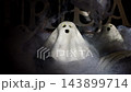Handmade clay ghost figurine displayed charming Halloween decoration. Handcrafted ceramic character features minimalist design with expressive facial details. Natural clay material 143899714