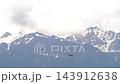 Golden eagle soaring over snowy peaks of Trans-Ili Alatau mountains 143912638