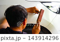 Removing dents on the car. PDR technology. Car body repair without painting. 143914296