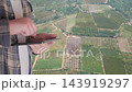 Concept of smart agriculture with farmer using tablet over aerial view of green field with innovation icons for solar energy, irrigation and IoT monitoring. . High quality 4k footage 143919297