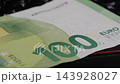 Close-up of 100 Euro banknote on black keyboard, showcasing detailed design 143928027