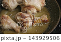 Oil heating up in a frying pan on a stove top 143929506
