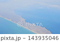 Argentina - October 11, 2026: Scenic aerial view of the coastline from a passenger airplane window, showing the natural boundary between land and water during a flight toward Patagonia. 143935046