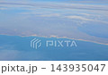 Argentina - October 11, 2026: Wide aerial view of the coastline and surrounding terrain from an aircraft window during a domestic flight toward Patagonia. 143935047