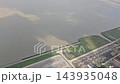 Argentina - October 11, 2026: Aerial view from a passenger airplane showing the coastline, water and surrounding land during a domestic flight across Argentina. 143935048