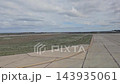 Trelew, Argentina - October 11, 2026: View through an airplane window during taxiing after arrival, showing airport pavement, airfield grounds and infrastructure at Trelew Airport. 143935061