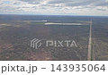 Argentina - October 11, 2026: Aerial view of roads crossing extensive dry plains in Patagonia, filmed through an airplane window during descent toward Trelew. 143935064