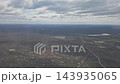 Argentina - October 11, 2026: Aerial view of roads running through extensive plains in Patagonia, with distant terrain and clouds visible during an aircraft descent toward Trelew. 143935065