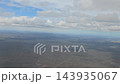 Argentina - October 11, 2026: Aerial footage of extensive Patagonian plains with scattered clouds overhead, recorded from an airplane window during the flight toward Trelew. 143935067