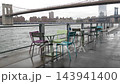 Manhattan Bridge, Brooklyn Bridge park, New York City Dumbo, USA. Waterfront chairs and tables, rain 143941400