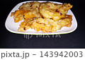 Crispy Indonesian Fried Fritters on White Plate, Street Food Snack, served on a white plate with a dark background. 143942003