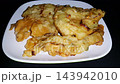 Appetizing Asian Fried Fritters on Plate with Copy Space. a popular Asian street food snack, served on a white plate 143942010