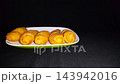 Indonesian Banana Molen Fried Street Food on Plate with Copy Space. Perfect for food blogs, menus, or advertising in East Asian markets, offering a taste of authentic Southeast Asian cuisine. 143942016