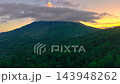 Aerial view of Mount Inerie volcano covered with clouds and surrounded by green tropical forests at 143948262
