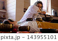 Close side view of singing bowls placed around a woman during a private sound bath, with a therapist playing a bowl nearby. Wellness rituals support comfort, calm focus, and self care. 143955101
