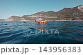 Freediving orange safety buoy in the open sea near the rugged coastline. High quality 4k footage 143956383