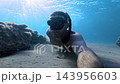 Man freediving and swimming underwater in blue sea, selfie of freediver. High quality 4k footage 143956603