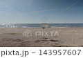 Glass of white wine in the sand on a sunny sea beach 143957607