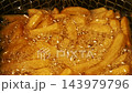 Close-up slow motion fried crispy potato wedges deep frying in oil. French fries 143979796