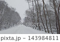 Pan across snowy winter road 143984811