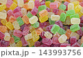 Close up of colorful sugar coated gummy jelly candies in assorted fruit colors. Sweet confectionery with sparkling sugar crystals, chewy texture and vibrant appearance. 143993756