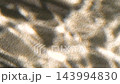 Slow motion blurred shadows of palm tree leaf rippled on water surface and sand 143994830