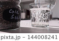 Chia Seeds Gel Formation in Water on Kitchen Counter Demonstrating High Fiber Hydration 144008241